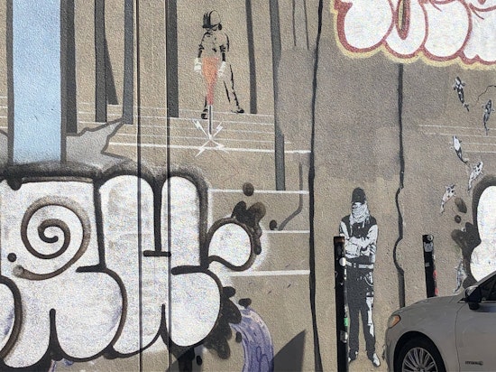 Banksy mural in the Mission marked up by taggers