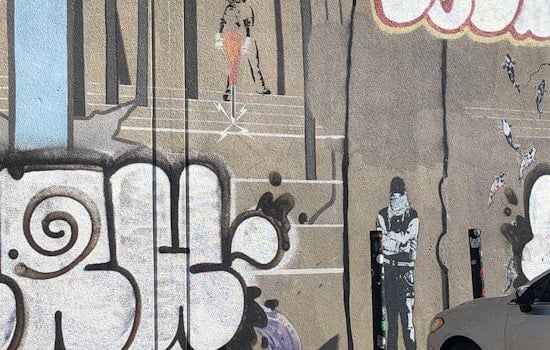 Banksy mural in the Mission marked up by taggers