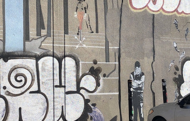 Banksy mural in the Mission marked up by taggers
