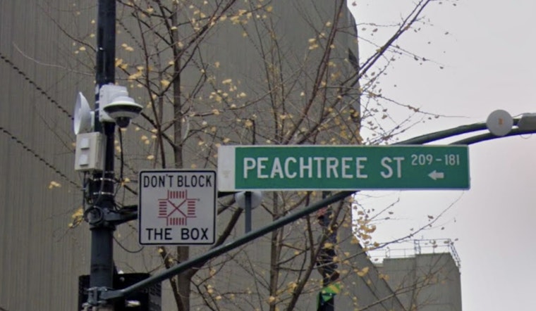 Massive Sinkhole Swallows Sign, Sidewalk on Peachtree Street in Buckhead, Impacting Traffic and Businesses