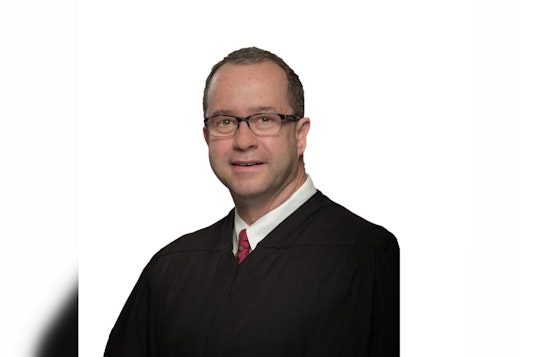 Texas Supreme Court Justice John Devine Under Scrutiny for Not Recusing in Controversial Sex Abuse Case Linked to Former Firm