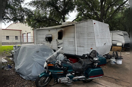 Houston Community Mourns as Fire Claims Life in Travel Trailer Blaze, Arson Investigation Underway