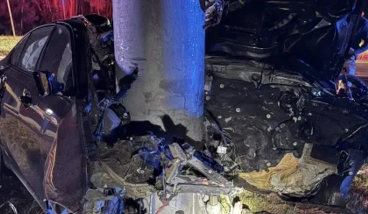 Driver Seriously Injured as Car Crashes into Pole and Catches Fire in Woburn, Massachusetts