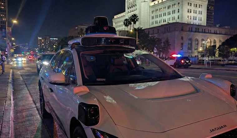 VIDEO: Waymo Robotaxi Casually Rolls through Active LAPD Standoff as Officers Confront Armed Suspect
