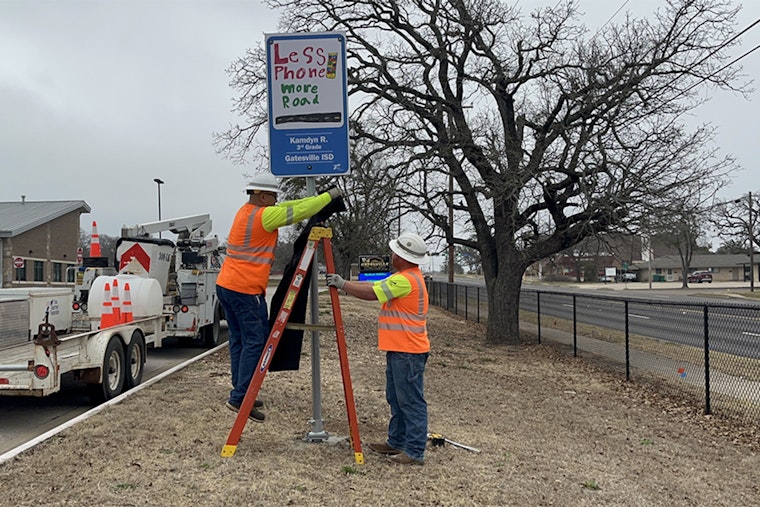 Waco Student's Safety Artwork Transforms into Roadside Reminder: "Less phone. More road."