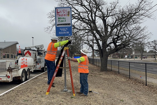 Waco Student's Safety Artwork Transforms into Roadside Reminder: "Less phone. More road."