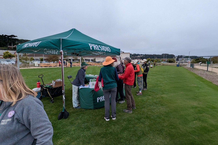 Information tent at the meadow with Presidio Trust staff providing visitor services