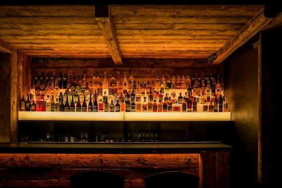 Chelsea's New VV's Cocktail Room Turns Steel Blue Shelving Into a Bar