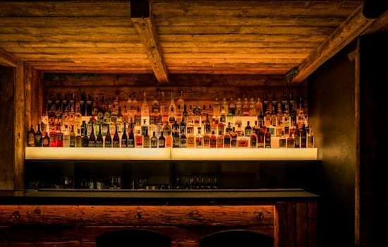 Chelsea's New VV's Cocktail Room Turns Steel Blue Shelving Into a Bar