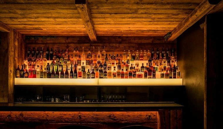 Chelsea's New VV's Cocktail Room Turns Steel Blue Shelving Into a Bar