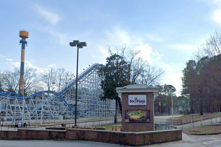 Riders Dangle on Six Flags Over Georgia's Goliath Coaster Mid-Track