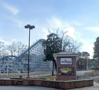 Riders Dangle on Six Flags Over Georgia's Goliath Coaster Mid-Track