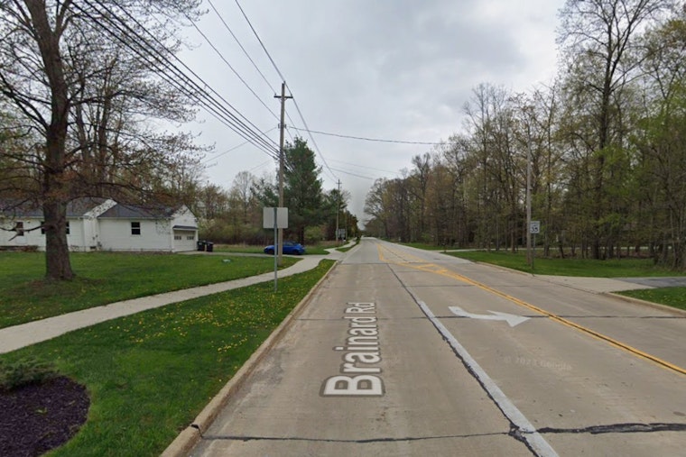 Orange Blaze Engulfs Home And Tree Line Near Busy Intersection