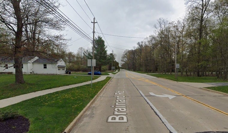 Orange Blaze Engulfs Home And Tree Line Near Busy Intersection