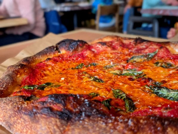 Rose Pizzeria Margherita pizza with blistered crust and basil