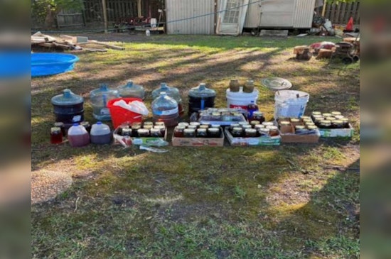 Faulty Blinker Leads Whiteville Cops To 18 Gallons Of Moonshine Stash