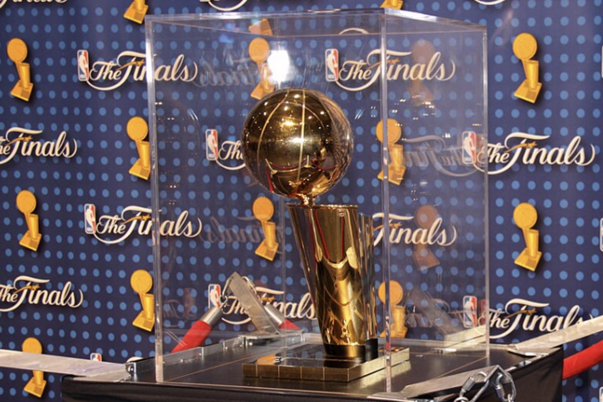 The NBA is going big for the Spurs–Knicks Finals, literally. The league has unveiled fresh court designs for the championship series that plant an oversized Larry O'Brien Trophy right at midcourt in both arenas. The artwork will be featured beneath each team's main logo at the Frost Bank Center in San Antonio and at Madison Square Garden in New York, marking the first time since 2009 that the jumbo trophy has taken over center court in the Finals.
