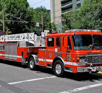 Portland Firefighters Investigate Burning Debris Pile Near Structure