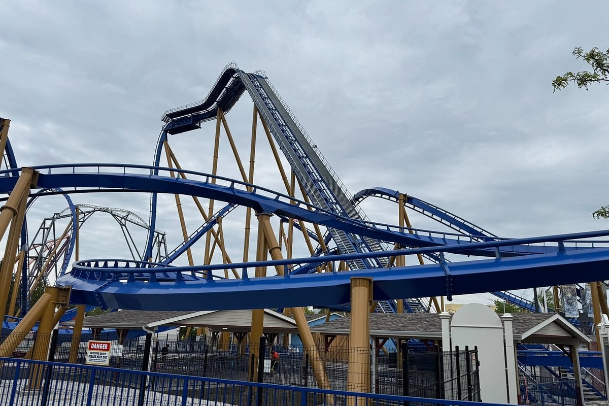 Six Flags Great America coaster stall — riders climb down track