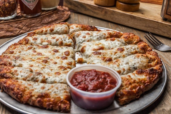 From Ashes to Slices: Mandeville’s McClain’s Pizzeria Reopens With Charred Cookbook, New Bar