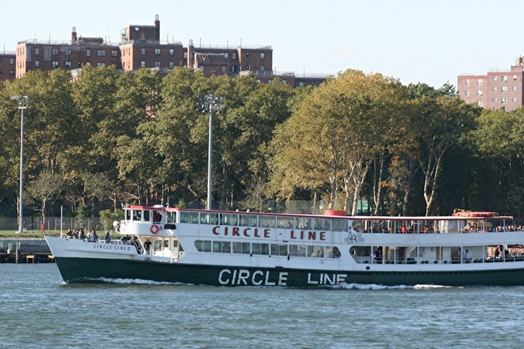 Circle Line's First Nighttime Dog Cruise Sails Past a Lit-Up Statue of Liberty
