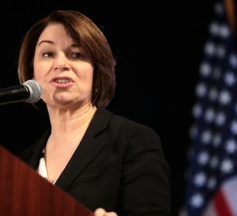 Klobuchar Pitches $180M Health Credit as Demuth Camp Fires Back on Costs