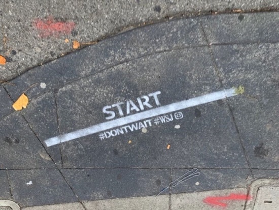Illegal advertising from the Wall Street Journal appears on city streets