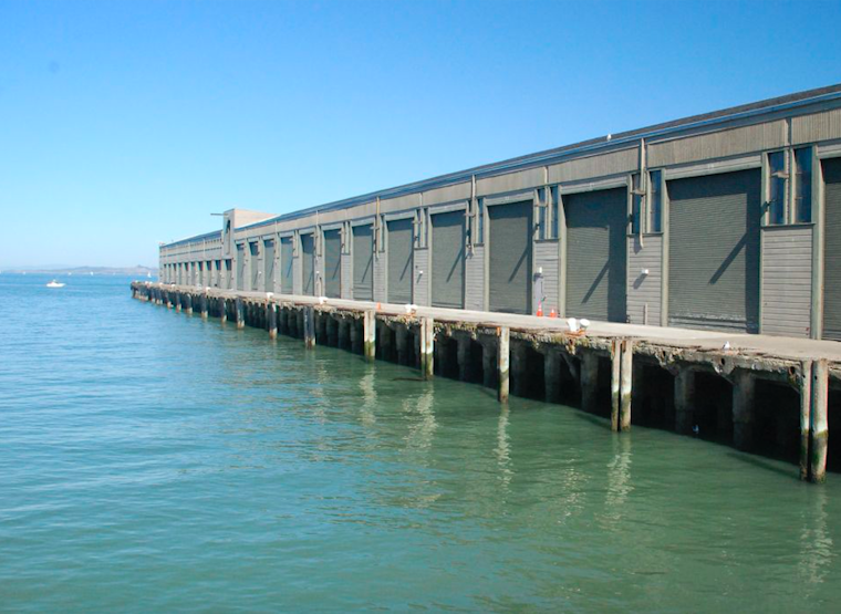 Rescue Divers Pull Elderly Woman From Water At Wharf
