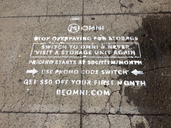 Mission Storage Facility's Sidewalk Covered In Stencils Promoting Competing Storage Startup