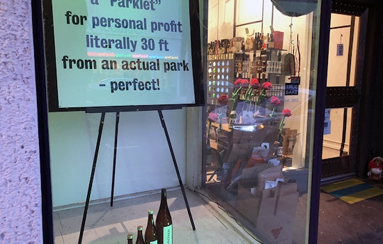 True Sake installs window sign protesting new Hayes Valley parklet