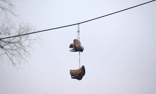 What Does it Really Mean When You See Shoes Hanging from a Telephone Wire?