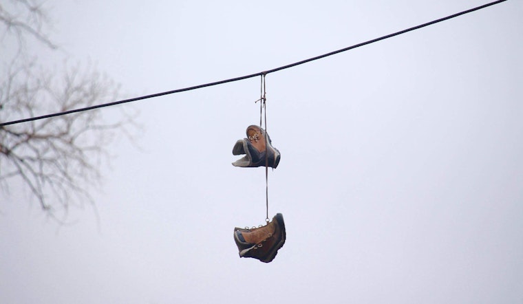 What Does it Really Mean When You See Shoes Hanging from a Telephone