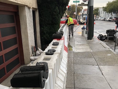 Temporary Flood Barriers Installed At Mission Intersection