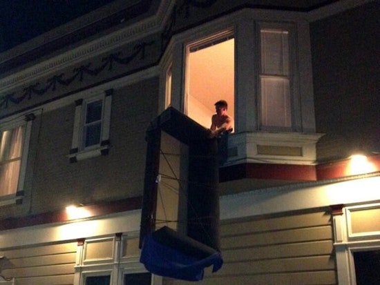 Watch Some Shirtless Dude Pull a Sofa Through a Window