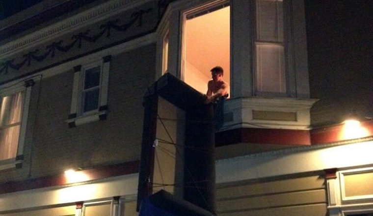 Watch Some Shirtless Dude Pull a Sofa Through a Window