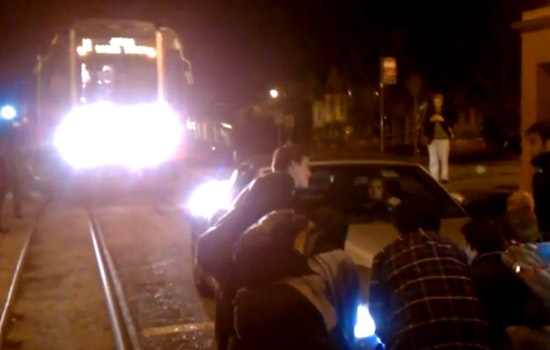 Muni Riders Lift Car Off Duboce Tracks