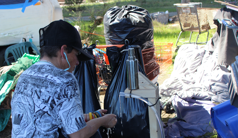 Oakland activists build hand-washing stations for unhoused, as city’s sanitation plan falls short